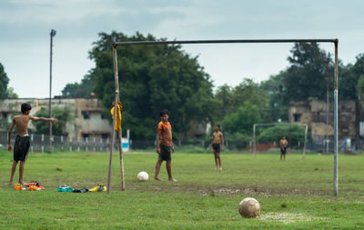 Group of people playing soccer on field