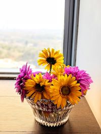 Close-up of yellow flower in pot on table