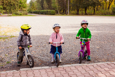 Children playing with bicycle in background