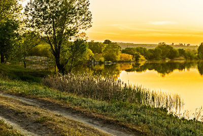 Scenic view of lake against sky during sunset