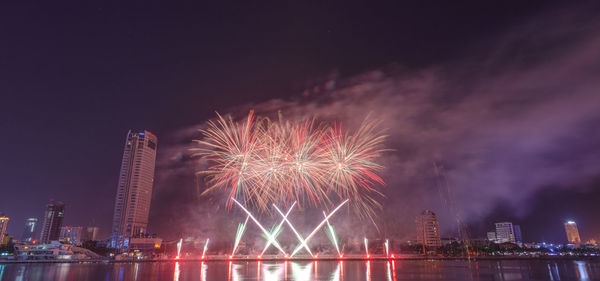 Low angle view of firework display at night