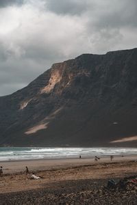 View of beach against cloudy sky