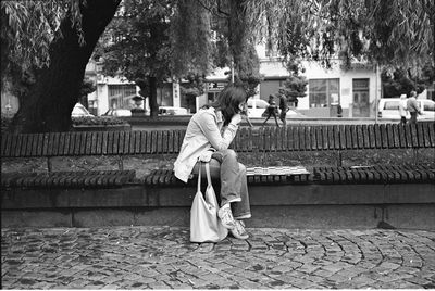 Woman sitting on bench at park