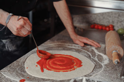 Midsection of man preparing food