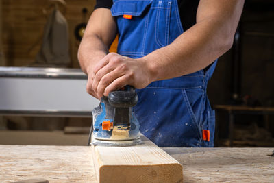 Midsection of man working in workshop