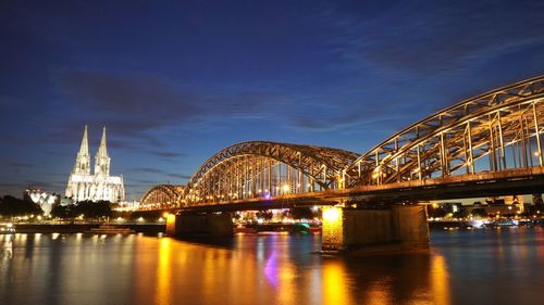 View of bridge over river at night