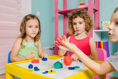 High angle view of siblings and woman on table