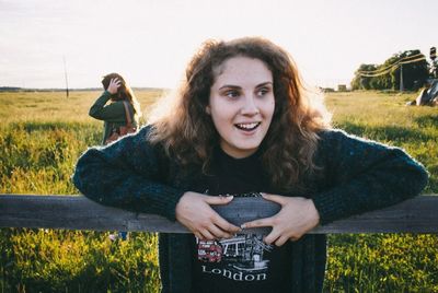 Portrait of young woman sitting on field