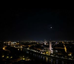 Illuminated cityscape against sky at night