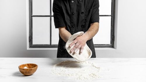 Portrait of man holding food at home