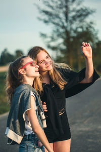 Girl gesturing by friend in city