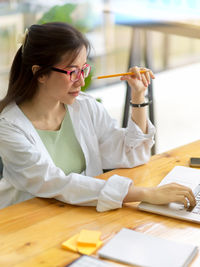 Portrait of woman working on table