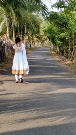 Woman walking on footpath