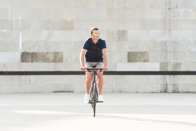 Full length of teenage girl riding bicycle