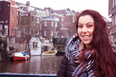 Portrait of smiling young woman in city