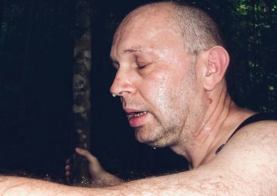 Close-up of tired man with wet face 