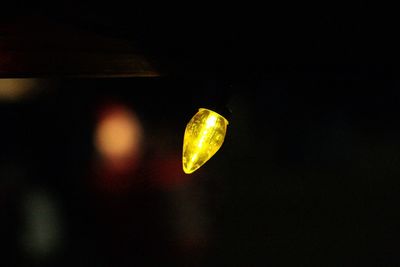 Close-up of illuminated lights against black background