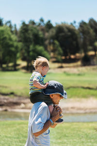 Side view of boy with umbrella