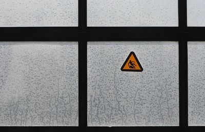 Wet floor sign on glass window