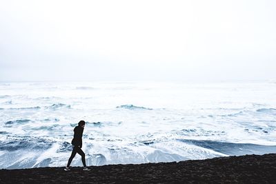 Silhouette of man in sea