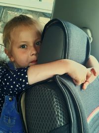 Portrait of cute girl sitting in car