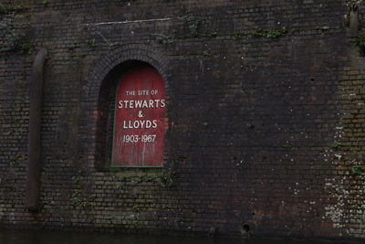 Text on brick wall of building