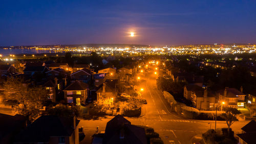 High angle view of illuminated buildings in city at night