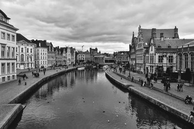 View of buildings in city against cloudy sky