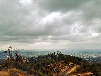 Cityscape against cloudy sky