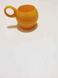 Close-up of yellow object over white background