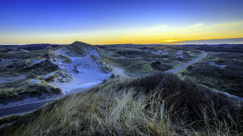 Scenic view of snow mountains against sky during sunset