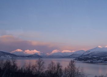 Scenic view of lake and mountains against sky during winter