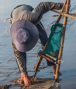 Full length of fisherman fishing on beach