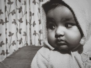 Close-up of cute baby girl at home