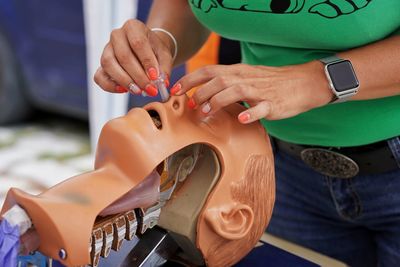 Midsection of man holding hat