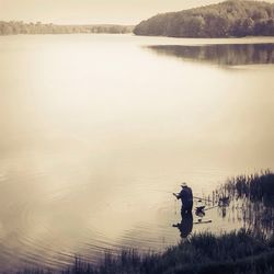 Reflection of people in lake