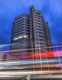 Low angle view of modern building against blue sky