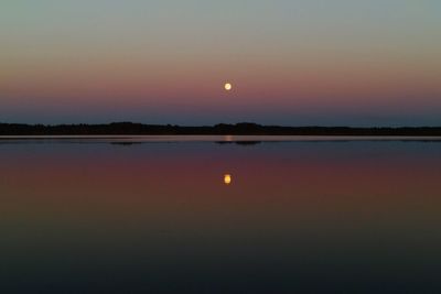 Scenic view of lake against romantic sky at sunset