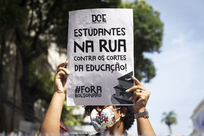 Low section of woman holding text on tree