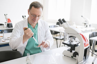 Researcher in white coat working in lab