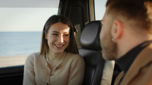 Happy boy and girl in the off road car during valentines day