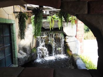 Water flowing through rocks against wall