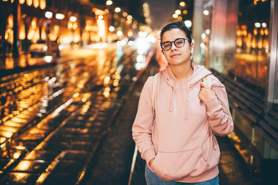 Portrait of young woman wearing sunglasses while standing in store