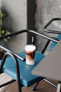 High angle view of chocolate drink on chair outdoors