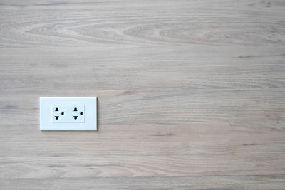 Electrical outlet on wooden wall