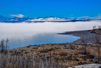 Scenic view of sea against blue sky during winter