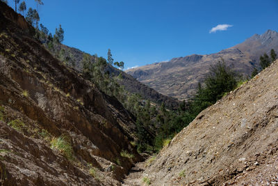 Scenic view of rocky mountains against blue sky