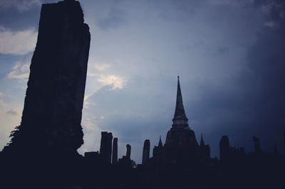 Silhouette of building against cloudy sky