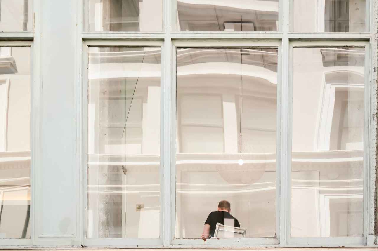 Rear view of a man in window