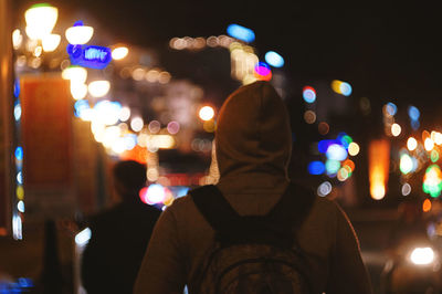 Rear view of man standing at night